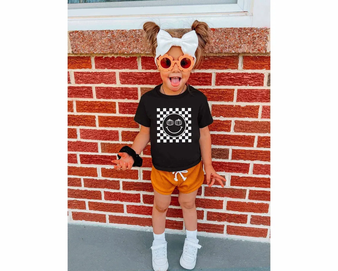 Pumpkin Checkered Smiley Face. Halloween T-shirt for Kids. Halloween Toddler Shirt. Pumpkin Baby Shirt. Fall Checkered Retro baby t-shirt.